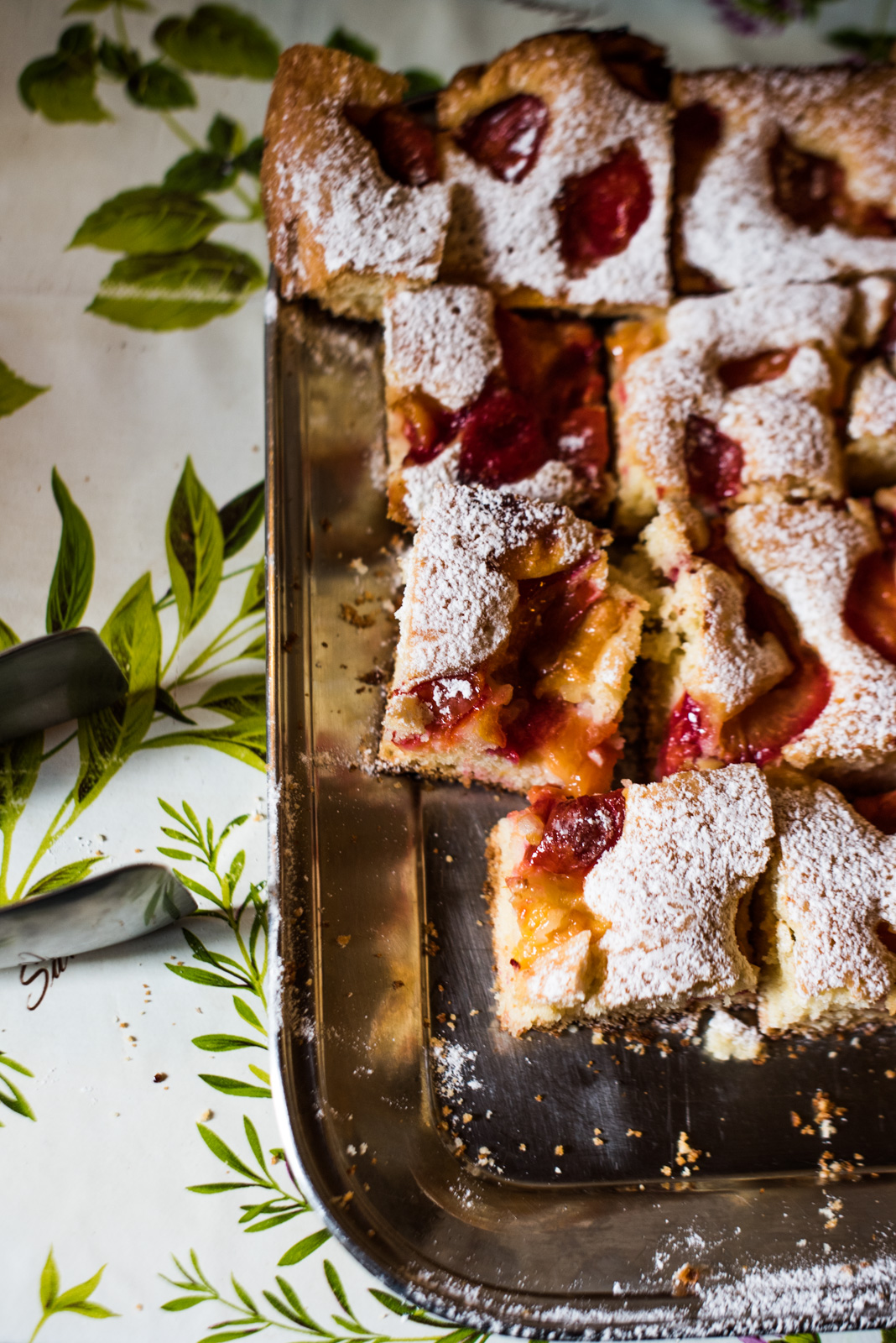 Freshly baked dessert with red and yellow jelly and powdered sugar