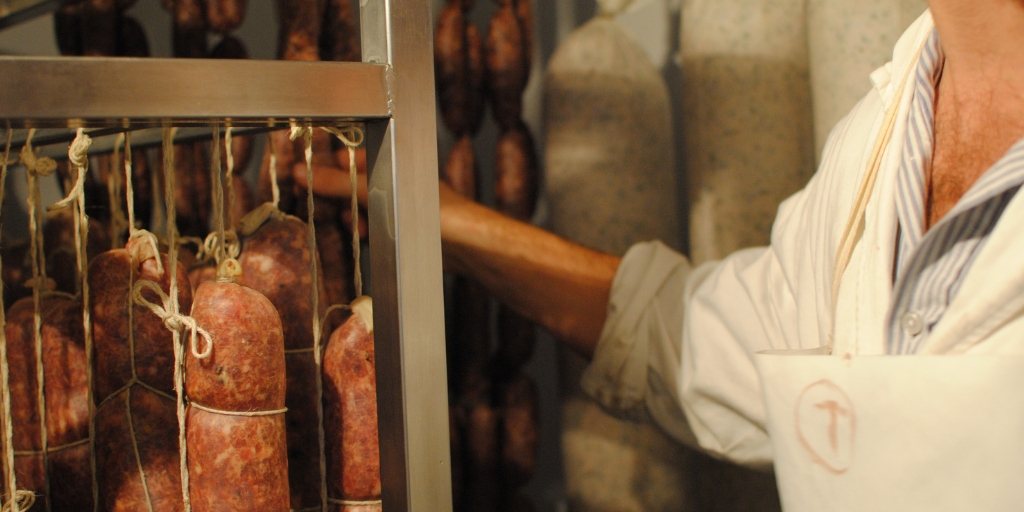 Butcher Apprentice hanging salumi