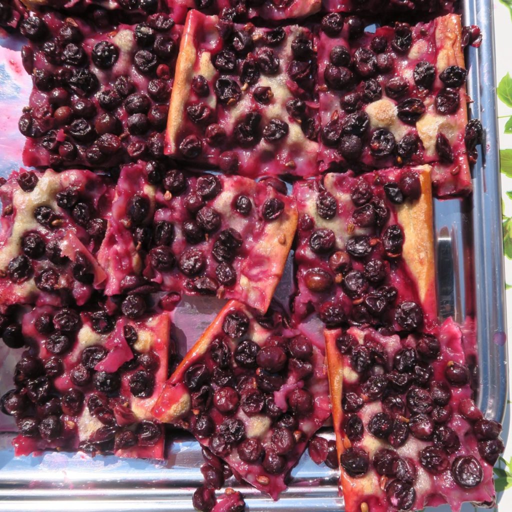 Slices of schiacciata con uva on a silver tray