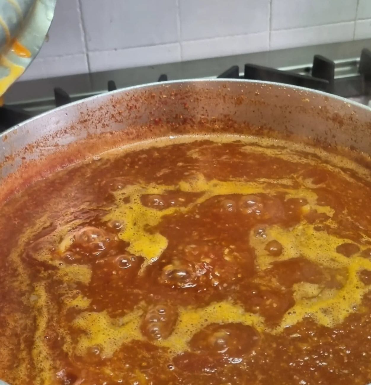 Aglione sauce in a big pot on the stove