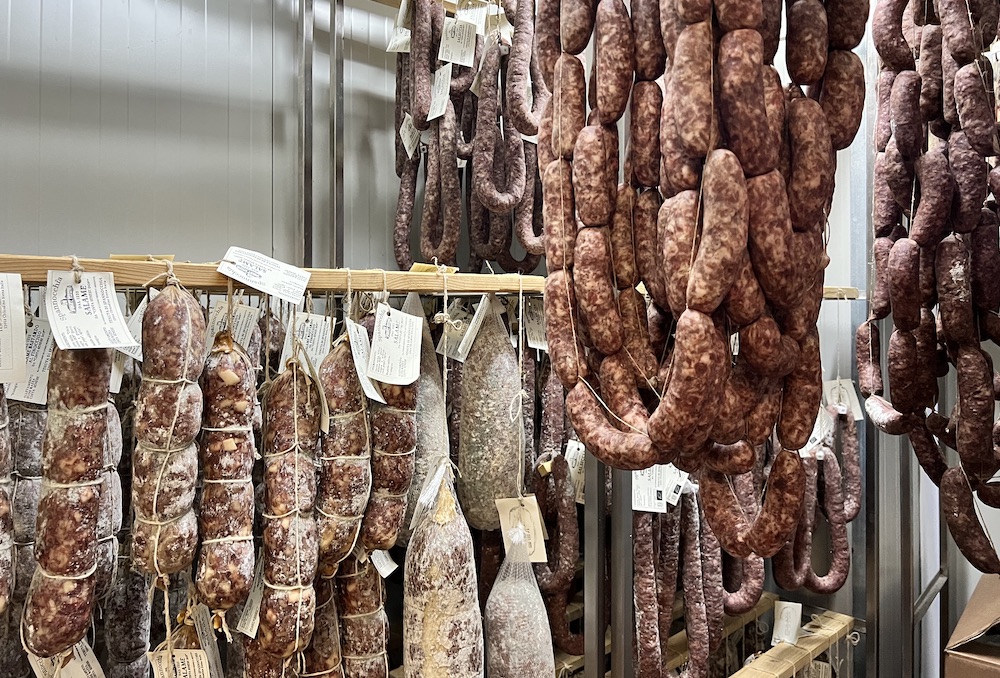Salumi hanging in the walk-in refrigerator.