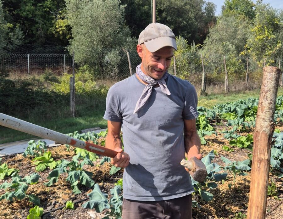 Yago holds a broken tool in the garden
